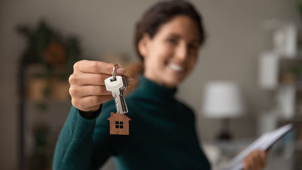 pessoa segurando chaves de casa após fazer financiamento de imóveis